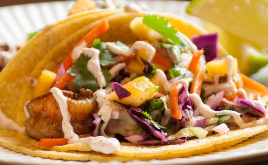 Photo of mango shrimp taco on plate.