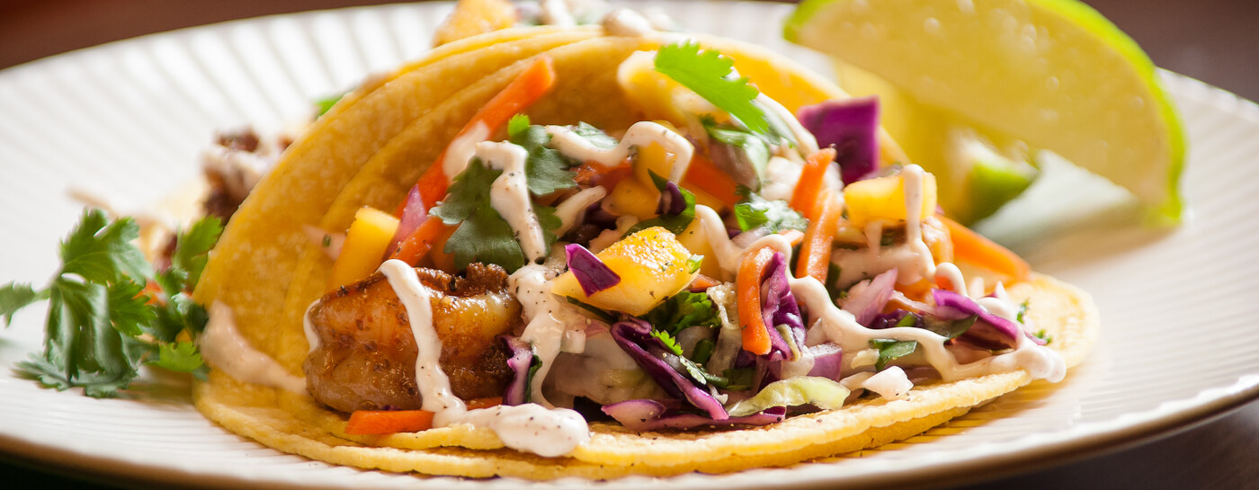 Photo of mango shrimp taco on plate.
